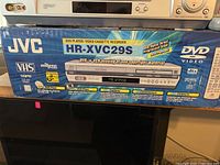 JVC HR-XVC29S DVD and VHS combination unit in original retail box with feature details visible.