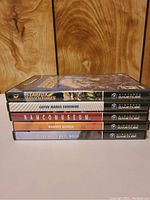 Stack of five Nintendo GameCube game cases on wooden background