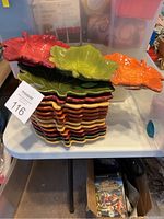 Stack of 12 colorful leaf-shaped snack plates and one leaf-shaped dip tray on top