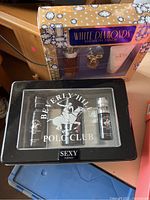 Elizabeth Taylor White Diamonds gift set boxed with perfume spray, miniature perfume, and body lotion Visible next to Beverly Hills Polo Club Sexy for Men tin with two small bottles
