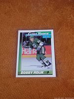 Front view of the Bobby Holik Super Rookie hockey card showing player in green uniform skating, with Super Rookie branding and O-Pee-Chee logo.