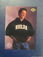 Front of the Doug Gilmour NHLPA hockey card showing him in a black NHLPA sweatshirt.