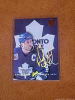 Front of Doug Gilmour Signature Series hockey card showing player image, team logo, and gold autograph.