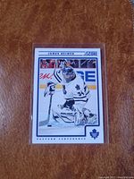 Front side photograph of the James Reimer hockey card in protective plastic sleeve showing player in Toronto Maple Leafs goalie uniform.
