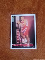 Front of Jerry Stackhouse basketball card in Philadelphia 76ers red uniform, climbing ladder.