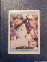 Front of Jose Canseco MVP baseball card showing batting action photo and card branding