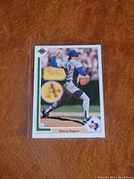 Front of 1989 Upper Deck Kenny Rogers baseball card #606 showing player pitching in uniform with Upper Deck logo.