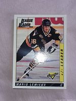 Front view of Mario Lemieux League Leader hockey card showing player skating.