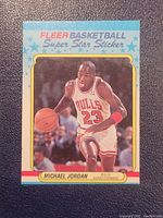Front of Michael Jordan Fleer Basketball Super Star Sticker showing basketball action image on card.