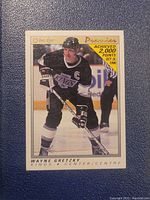 Front view of 1989-90 O-Pee-Chee Premier Wayne Gretzky hockey card featuring Gretzky in Los Angeles Kings uniform during a game.