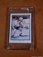 Front of Alexander Mogilny rookie card, showing player on ice in Sabres jersey inside plastic holder