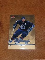 Front of 2005-06 Fleer Ultra hockey card showing Todd Bertuzzi in Vancouver Canucks uniform with gold background and foil 'Bertuzzi' name.