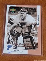 Front side of Upper Deck Retro Curtis Joseph hockey card showing Curtis Joseph in goalie gear with St. Louis Blues jersey, Upper Deck Retro logo, and retro sepia-tone design.