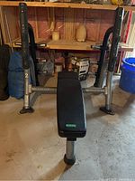 Full front view of the Matrix weight bench showing padded bench and barbell rack frame