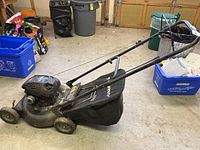 Side view of Murray Pro Series lawn mower showing fabric grass bag, handle, and wheels.
