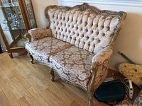 Front and side view showing overall shape, tufting, and wood frame details.