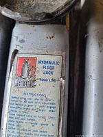 Close-up photo of the Pro-Lift Hydraulic Floor Jack label with specifications and instructions showing 4000 lbs capacity.