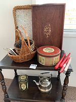 Full view of the lot with side table and items including trays, tins, kettle, candles