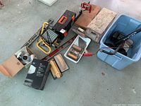 Overview of lot showing halogen light, mitre box, respirator, masks, levels, trowels, clamp, sanding block, and other tools.