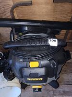 Top view of Dewalt shop vac showing power cord wrapped around handle and yellow power button.