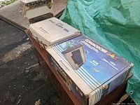 Commodore 64C box next to 1541 drive box on wooden table