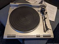 Full view of the Pioneer turntable showing the platter, tonearm, and control buttons.