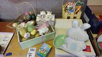 Basket containing 20 stone Easter eggs, assorted colors and patterns, some with natural stone texture