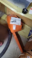 Plastic Stihl carrying case closed with instruction manual sheet on top