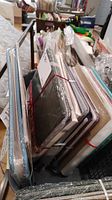 Six scrapbooking albums stacked and secured with red elastic bands, plastic wrapped, showing various cover styles and sizes