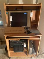 Setup including Dell 19-inch monitor, Dell computer tower, Lenovo computer tower, wired keyboard and mouse, Dell speakers, placed on wooden computer desk with shelves