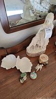Marble figurine girl with dog, leaf dish, dog pottery dish, Lenox candy dish, flower, sheep figurine. Sheep displays ear breakage and leg repair.