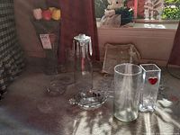 Photo showing various glassware including vases, tulips, candy dishes, and ashtrays