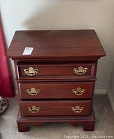 Photo of the Lexington three drawer end table from front showing scratches and wear.