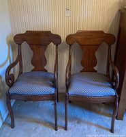 Front view of two matching Pennsylvania house arm chairs showcasing wooden frame and upholstered seats