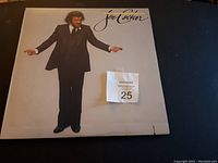 Front cover of Joe Cocker vinyl record album showing full figure of Joe Cocker wearing a suit with album title and artist name.