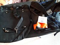 Bike rack bags displayed on table, showing front and top sides with straps and buckles visible.