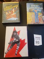 Two DVDs shown side by side, Great Expectations and David Copperfield, along with a third DVD featuring a hockey player against a maple leaf.