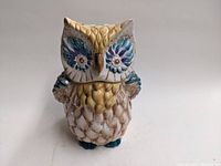 Front view of owl cookie jar showing detailed facial features and colors.