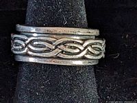 Close-up image of sterling silver Celtic knot spinner ring, showing detailed knot design and external ring bands.