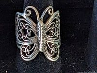 Close-up front view of sterling silver filigree butterfly ring showing detailed design and texture.