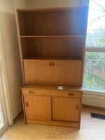 Full view of two-piece teak veneer cabinet in room