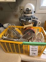 Mixer and yellow basket of utensils on countertop