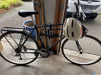 Side view of Marin San Rafael bike showing frame, wheels, handlebars, helmets and lock attached