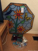 Octagonal panel leaning against wall with butterfly and flowers design
