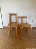 Four stools grouped against wall showing all sizes and design