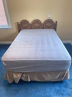 Full view of the bed showing mattress, box spring, and bed skirt.