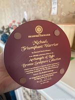 Back of a figurine base showing branding and model information. Bradford Exchange 'Michael: Triumphant Warrior' from Archangels of Light Bronze Sculpture Collection by Howard David Johnson, 2015.