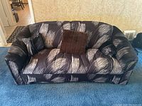 Front view of the retro upholstered couch showing pattern and cushions