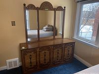 Wood veneer dresser showing front with six doors and decorative veneer pattern and handles