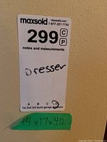 Photo of label showing lot number 299 and dimensions 44x17x40